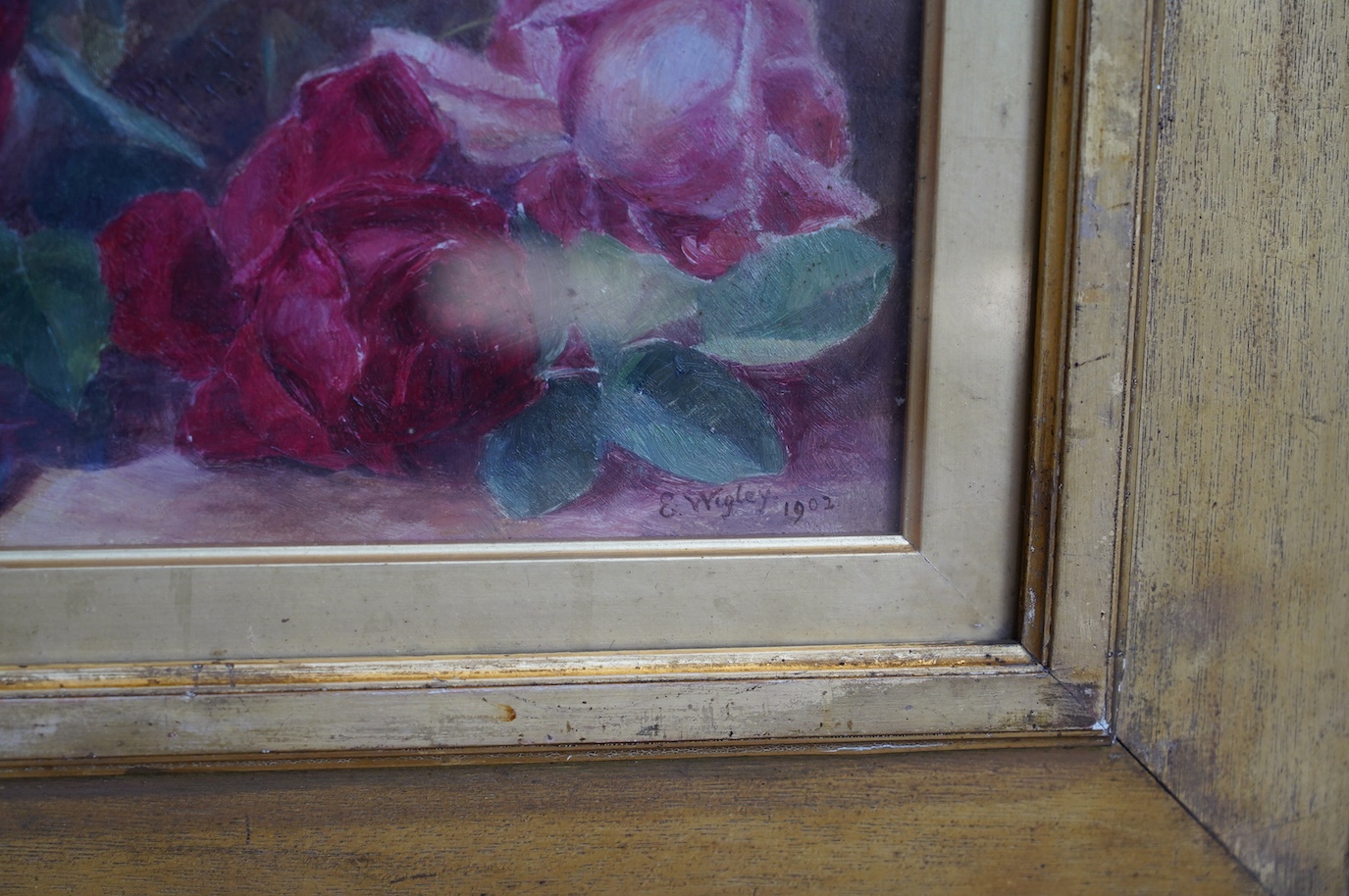 Edith Wigley, oil on canvas, Still life of roses, signed and dated 1902, 16.5 x 44cm, gilt framed. Condition - fair to good